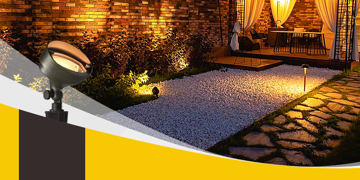 Adjustable landscape spotlight illuminating a stone pathway